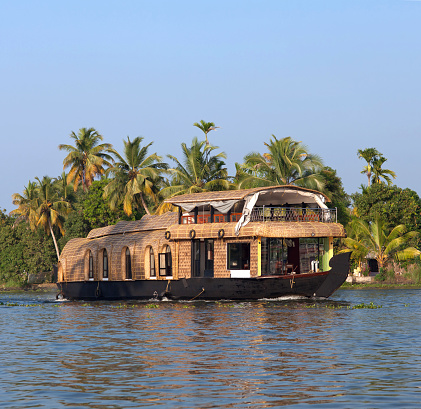 Aleppey, India - Novenber 7, 2016: Tourists on houseboat floating on backwaters in Kerala State, South India