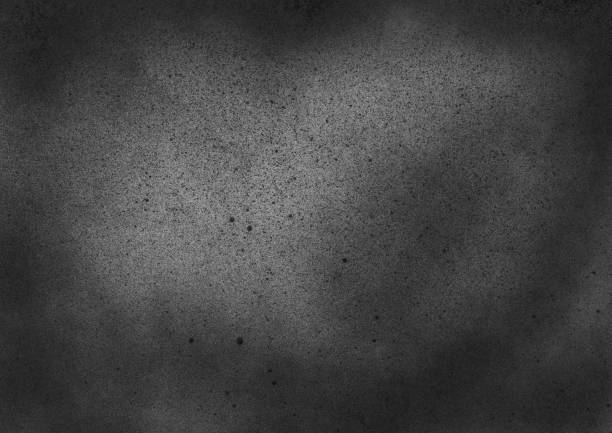 istock Subtle grain texture. Abstract black and white gritty grunge background. Dark paint spray particles on paper 1047083356