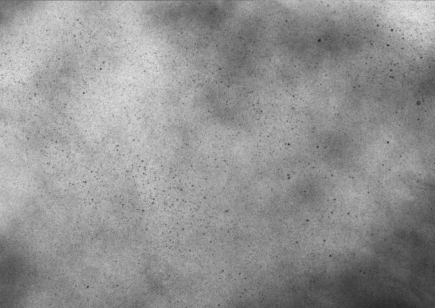 istock Subtle grain texture. Abstract black and white gritty grunge background. Dark paint spray particles on paper 1047083360