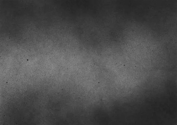 Photo of Subtle grain texture. Abstract black and white gritty grunge background. Dark paint spray particles on paper