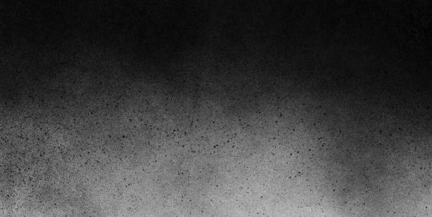 istock Subtle grain texture. Abstract black and white gritty grunge background. Dark paint spray particles on paper 1047083368