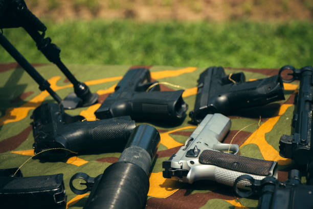 istock Pistols outdoor on camouflage background. 1047086680