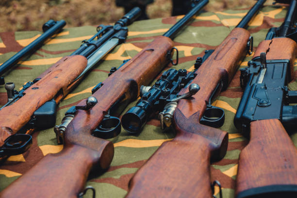 istock Different types of rifles guns outdoor on the table. 1047086914
