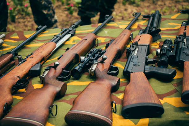 istock Different types of rifles guns outdoor on the table. 1047086964