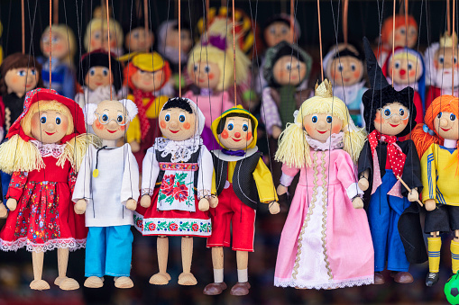 A variety of puppets for sale in a market stall in central Prague, Czech Republic.