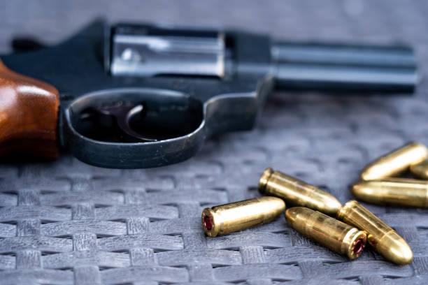 istock Close up view of bullets and handgun. 1047090600