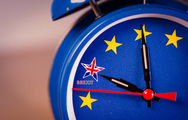 Blue alarm clock with EU stars, a UK flag marked "Brexit," symbolizing urgency or countdown related to Brexit.