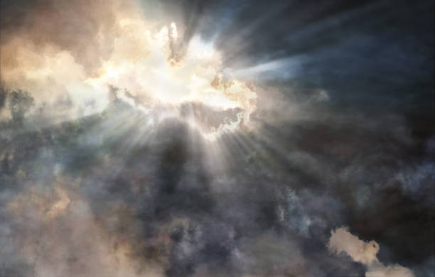 istock Light beams struggling through the storm clouds 1047099650