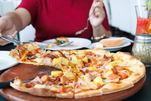 istock Woman hands taking slices of Pizza 1047101730