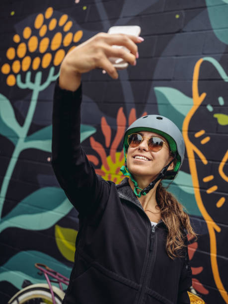 Young woman biking selfie