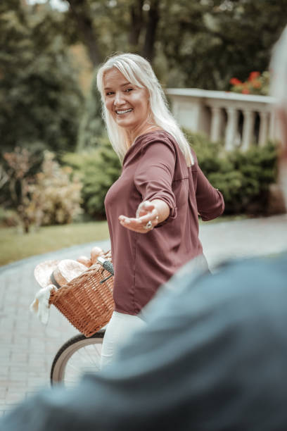 istock Cheerful mature woman stretching her left hand 1047102146