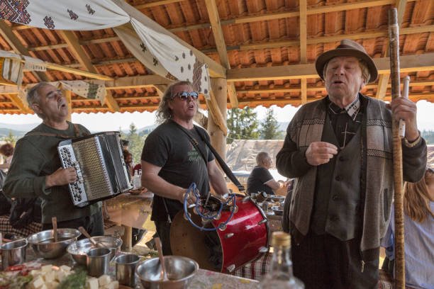 Folk musicians play music. Yablunytsia, resort Bukovel, Ukraine. YABLUNYTSIA, UKRAINE - SEPTEMBER 12, 2018: Folk musicians play music and sing song on mountain valley Peppers, place for rest and entertainment, close to famous winter resort Bukovel. bukovel ski resort ukraine stock pictures, royalty-free photos & images