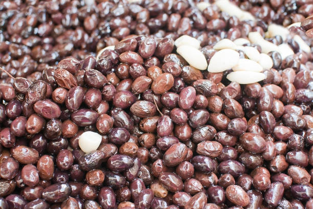 istock Dark olives full frame background with garlic 1047112076