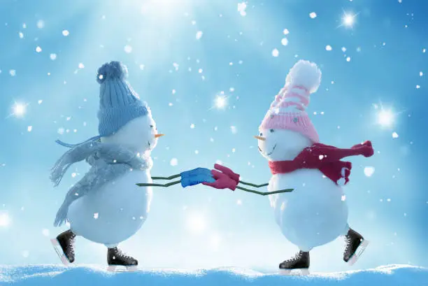 Photo of Merry christmas and happy new year greeting card .Two ice skating  snowmen