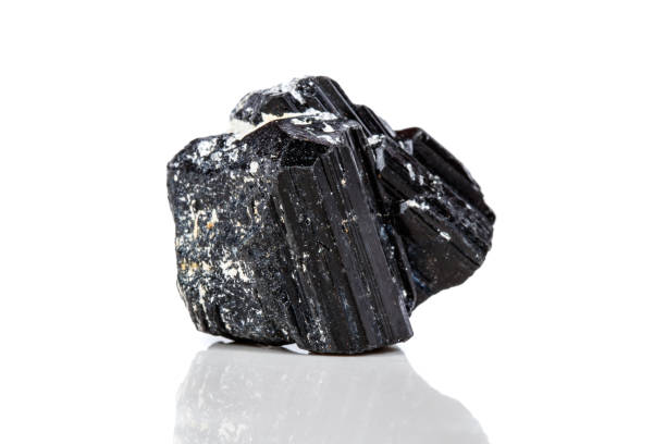 istock macro mineral stone sherle, schorl, black tourmaline on white background 1047115884