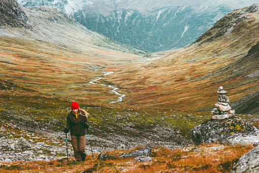 Traveler woman hiking in scandinavian mountains Travel Lifestyle wanderlust concept adventure active vacations outdoor