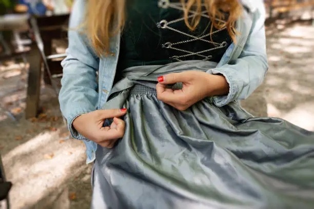 a young woman tying a knot in her apron