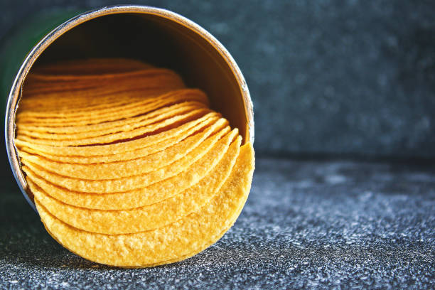 istock Crispy chips in a jar on a gray dark table. Snack. 1047128700