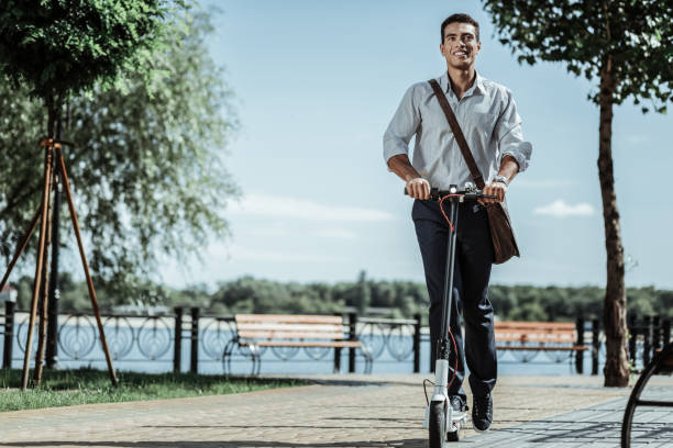 istock Attractive positive guy testing new electric scooter 1047129438