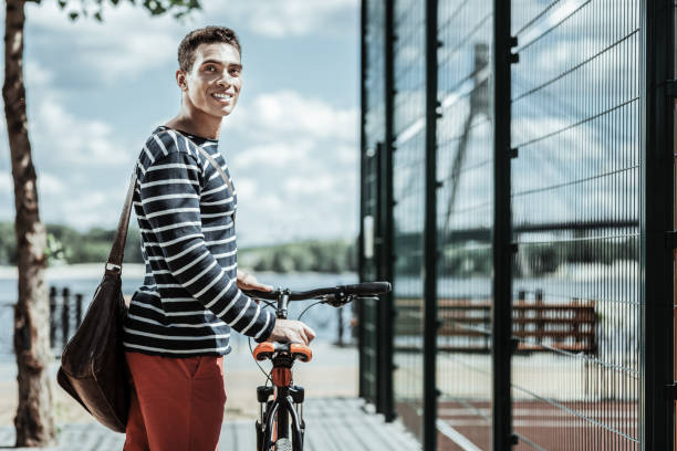 istock Positive energetic guy choosing bicycle for riding 1047129698