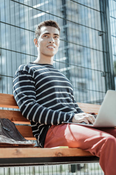 istock Handsome male freelancer responding on business correspondence 1047129700