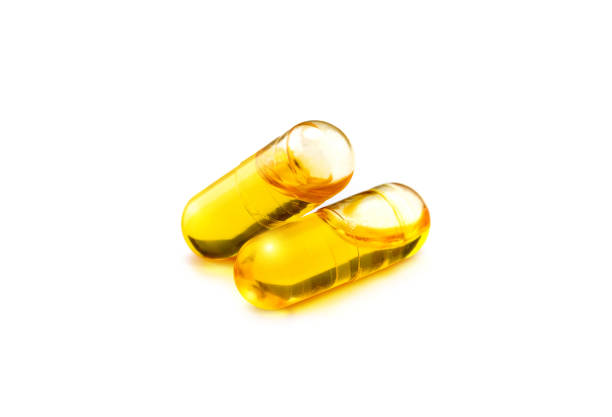 istock Fish oil supplement capsules isolated on white background 1047129714