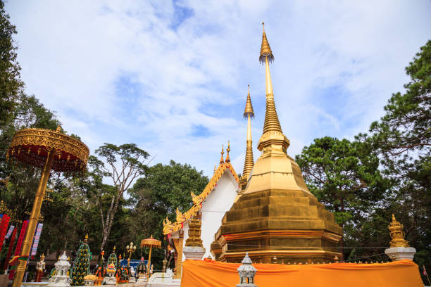 Wat Phra That Doi Tung temple with public domain has two golden pagodas or stupas containing Buddha's relic, considered as a treasure of Buddhism, Mae Sai, Chiang Rai, Thailand. Thai Travel Tourism. Wat Phra That Doi Tung temple with public domain has two golden pagodas or stupas containing Buddha's relic, considered as a treasure of Buddhism, Mae Sai, Chiang Rai, Thailand. Thai Travel Tourism. public domain photos stock pictures, royalty-free photos & images
