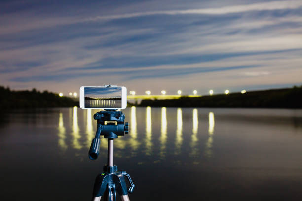 istock Using smartphone like professional camera on tripod to capturing night landscape 1047133738