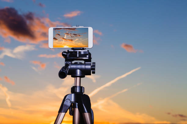 istock Smartphone on tripod capturing image of stunning sundown 1047133846