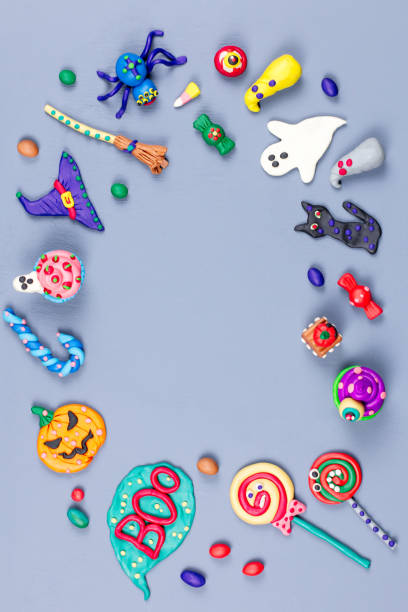 istock Halloween frame with decorations. Black cat, bats, witches hat and broomstick with orange pumpkins. Top view 1047133876