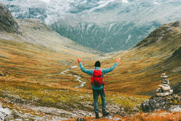 Man happy raised hands with backpack exploring mountains Travel heathy lifestyle concept active weekend summer vacations wild trek in Scandinavia Man happy raised hands with backpack exploring mountains Travel heathy lifestyle concept active weekend summer vacations wild trek in Scandinavia heathy stock pictures, royalty-free photos & images