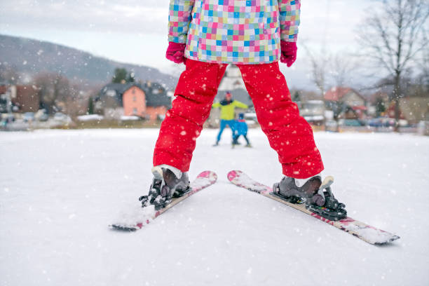 istock Little girl preparing to ski downhill 1047143076