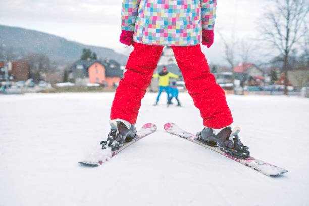 istock Little girl preparing to ski downhill 1047143078
