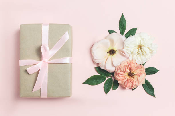 istock Gift box with roses on pink bacground. 1047145716