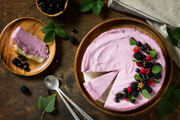 istock Cake with Black Currant Cream Souffle and Biscuit on a table in a rustic style. Top view flat lay background. Copy space. 1047145730