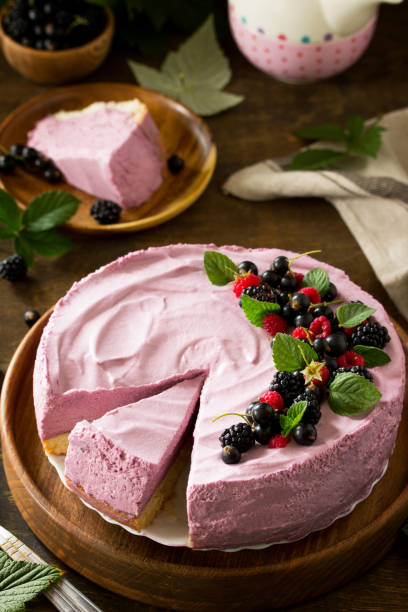 istock Cake with Black Currant Cream Souffle and Biscuit on a table in a rustic style. 1047145756