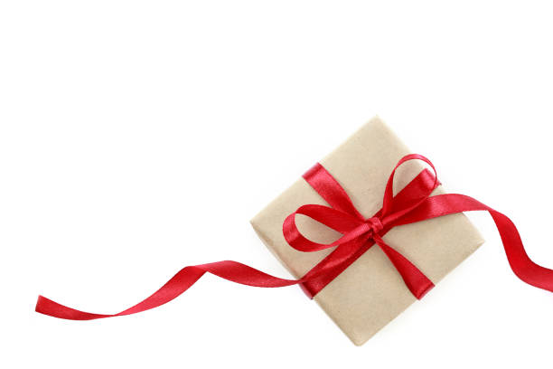 istock Present or gift box in a craft paper with gold ribbon bow 1047145776