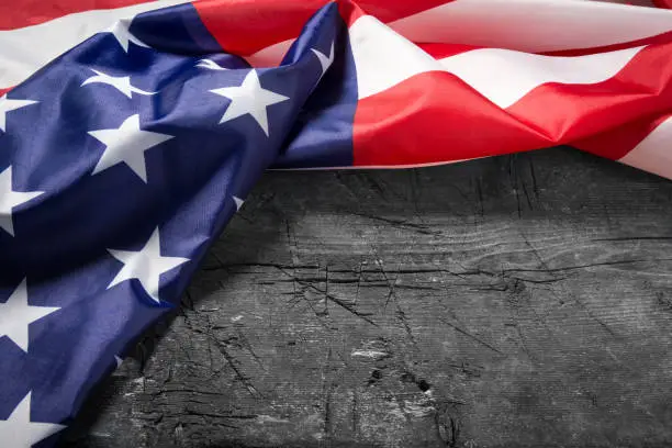 Photo of American flag lying on old wooden board