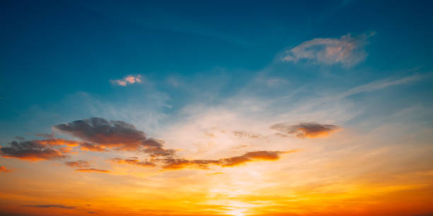 istock Sunset Sunrise Sky Background. Bright Dramatic Sky In Yellow, Orange And Blue Colors 1047146524