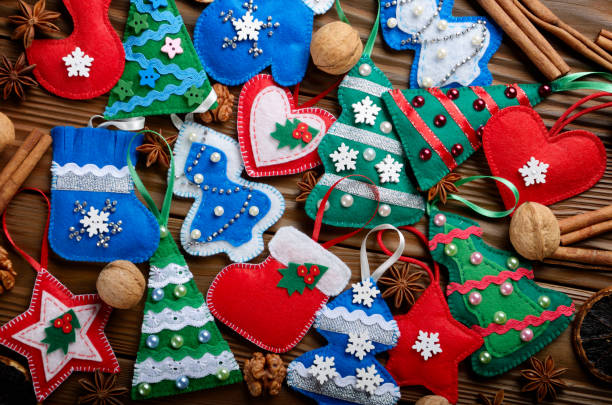 istock Assorted handmade rustic felt Christmas tree decorations with anise cinnamon and walnuts on wooden table 1047147402