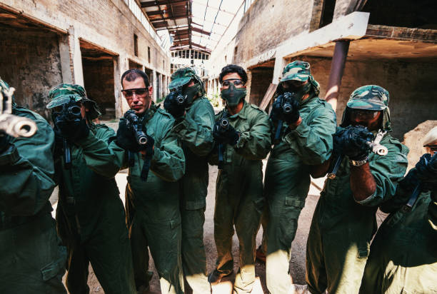 Young woman in full gear playing paintball