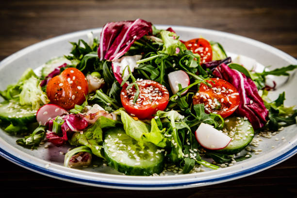 istock Vegetable salad on wooden background 1047159450