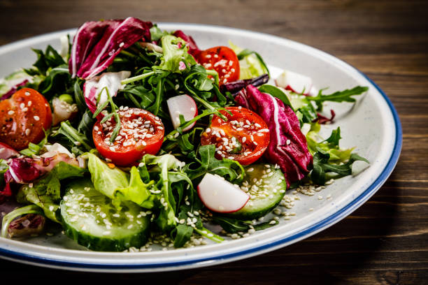 istock Vegetable salad on wooden background 1047159832