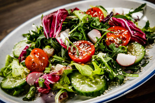 istock Vegetable salad on wooden background 1047159920