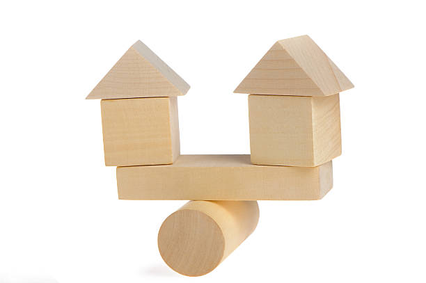 istock Wooden houses on abstract scales 104716009