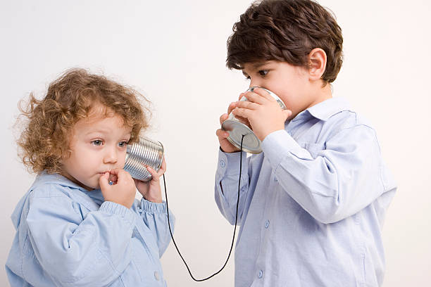istock One Little Girl And Boy Talking On Tin Can Phone 104716176