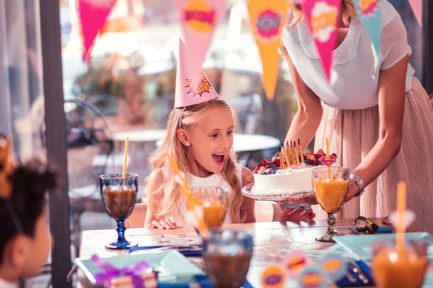 istock Emotional girl feeling excited while looking at her birthday cake 1047163376