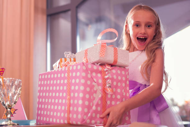 istock Emotional girl looking excited while holding her presents 1047163622
