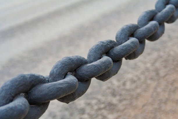 istock Close up view on a black Iron chain on a neutral blur background 1047166750