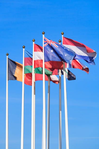 istock Flags of different countries, flutters in the wind, a background of clear blue sky 1047166908